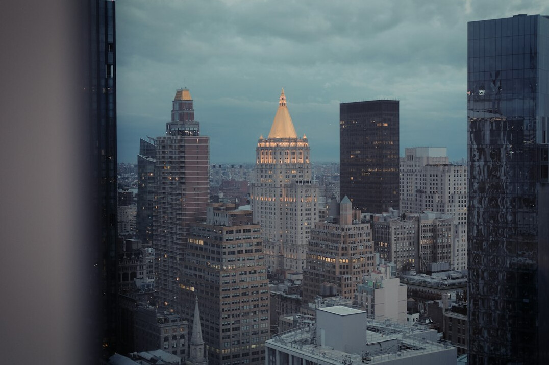 City skyline at dusk with illuminated windows