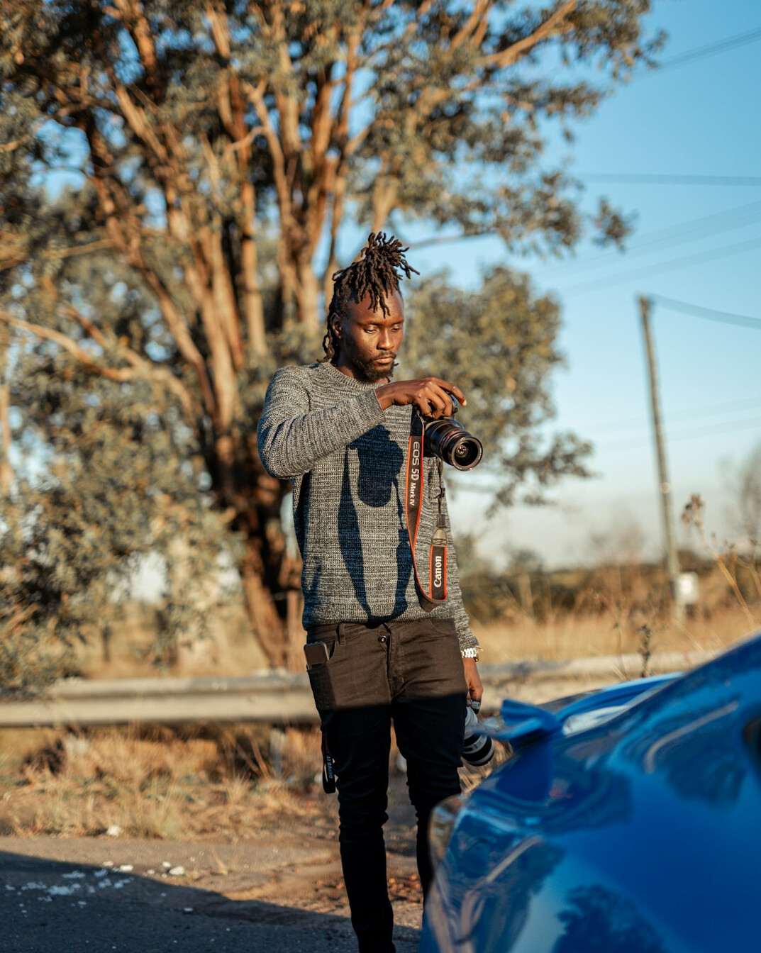 Portrait of a documentary photographer with a camera strap
