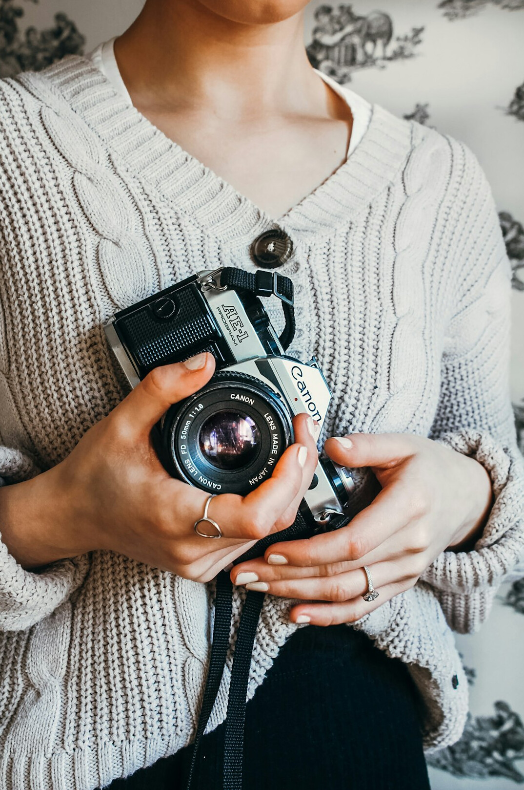 Portrait of a woman photographer holding a vintage camera