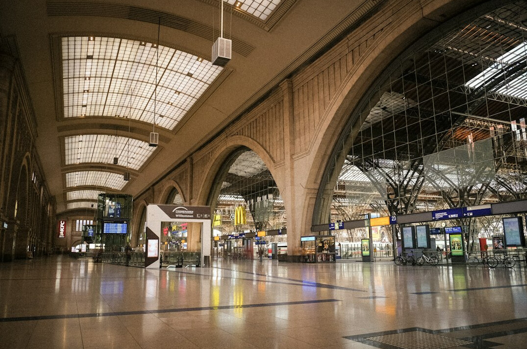 Empty grand train station hall with morning light